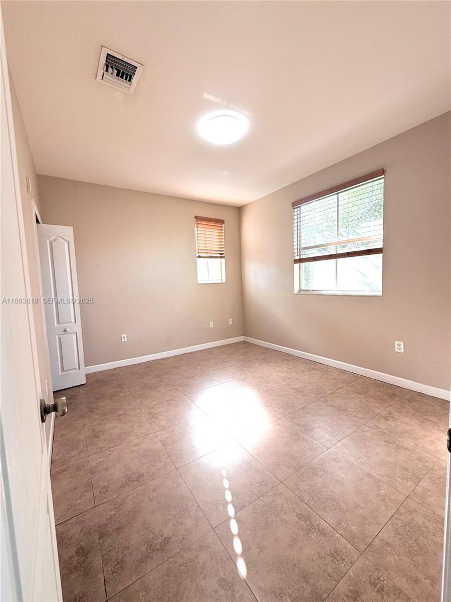 1656 Southeast 29th Court, Unit 207 Homestead, FL 33035 - Photo 6 of 31 an empty room with windows
