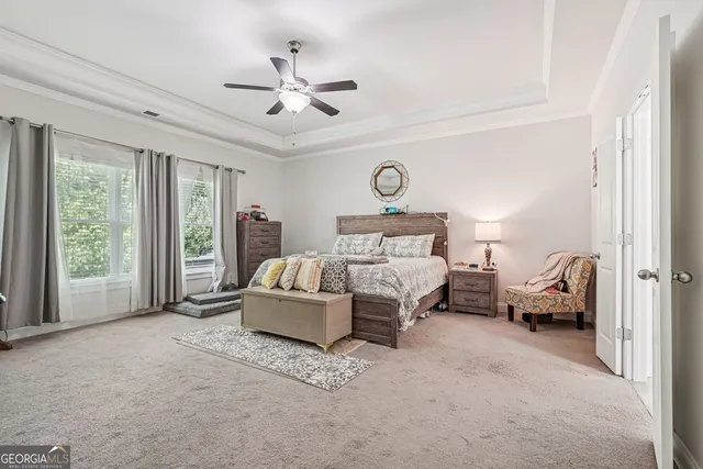 a bedroom with a bed couch and window