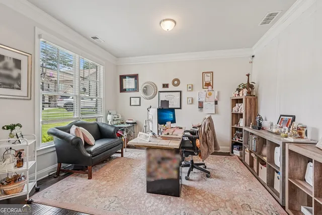 a living room with furniture and a book shelf