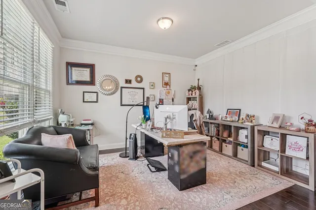 a living room with lots of furniture and baby bed