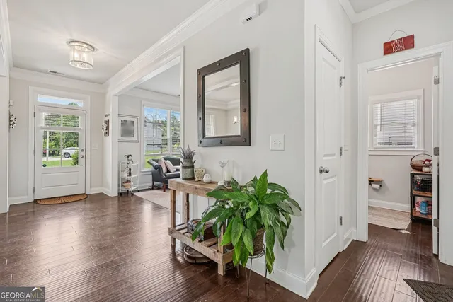 a hallway with wooden floor and furniture