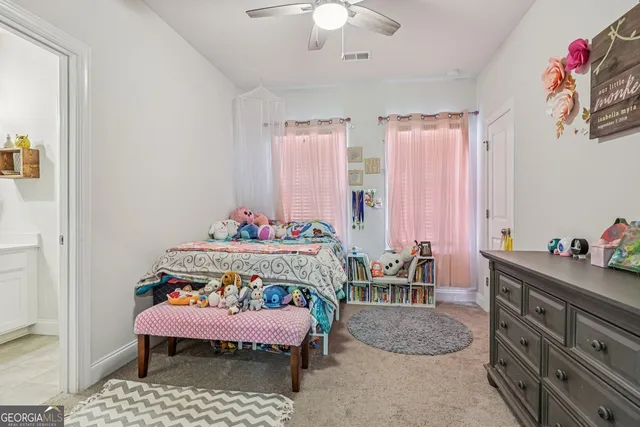 a bed room with a bed and a chair