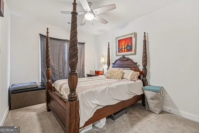 a bedroom with a bed and lamp