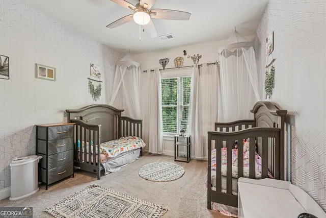 a bedroom with a bed a couch and dresser