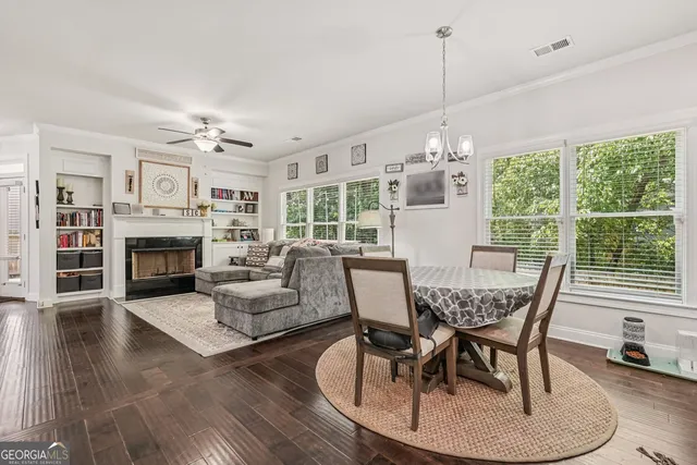 a view of a dining room with furniture wooden floor and chandelier