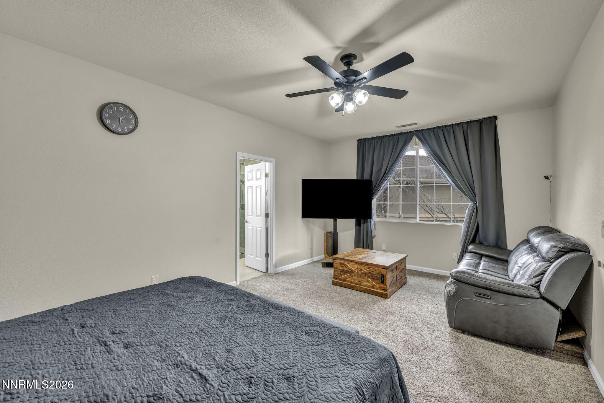 11010 Colton Drive Reno, NV 89521 - Photo 12 of 27 a bedroom with a bed and a chandelier