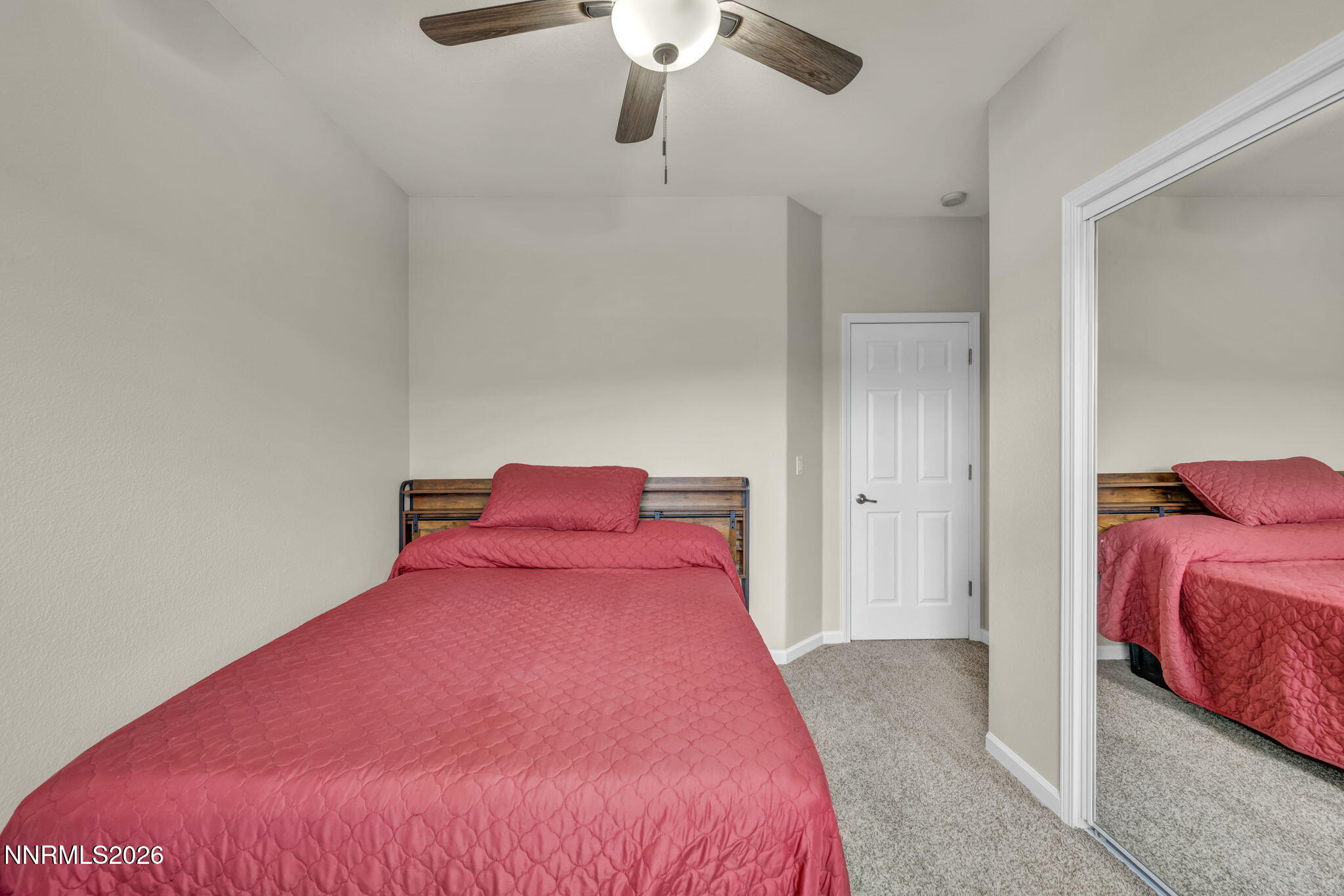 11010 Colton Drive Reno, NV 89521 - Photo 18 of 27 a bedroom with a bed and a chandelier