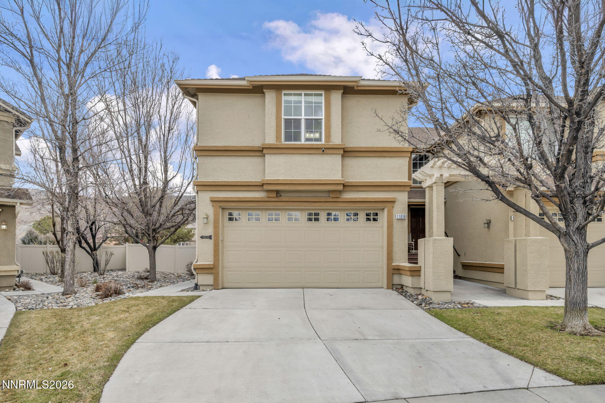 11010 Colton Drive Reno, NV 89521 - Photo 2 of 27 a front view of a house with a yard and garage