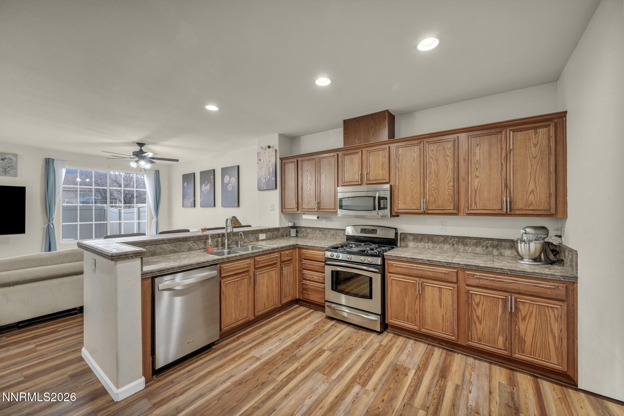 11010 Colton Drive Reno, NV 89521 - Photo 10 of 27 a kitchen with stainless steel appliances granite countertop wooden cabinets a sink and a stove