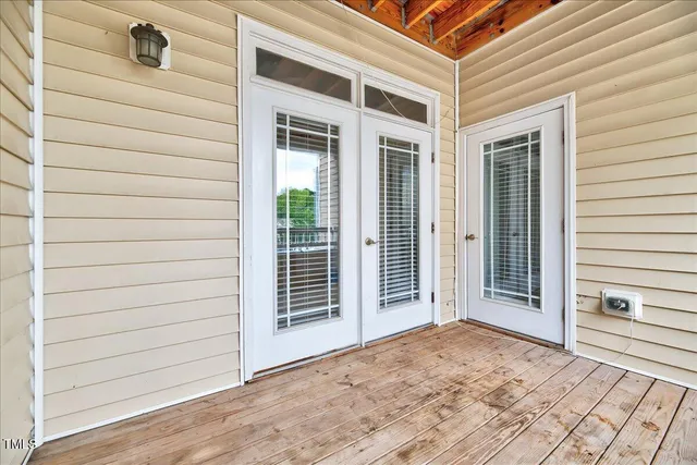 a view of a house with a door and wooden floor