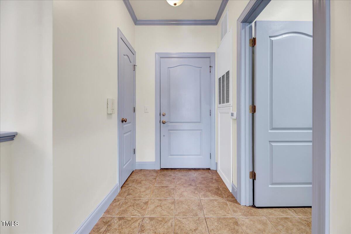 Undisclosed Address Raleigh, NC 27604 - Photo 3 of 22 a view of a hallway with closet and wooden floor