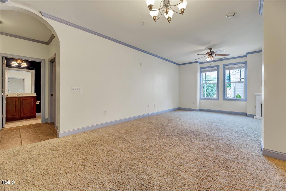 Undisclosed Address Raleigh, NC 27604 - Photo 4 of 22 en empty room with windows and ceiling fan