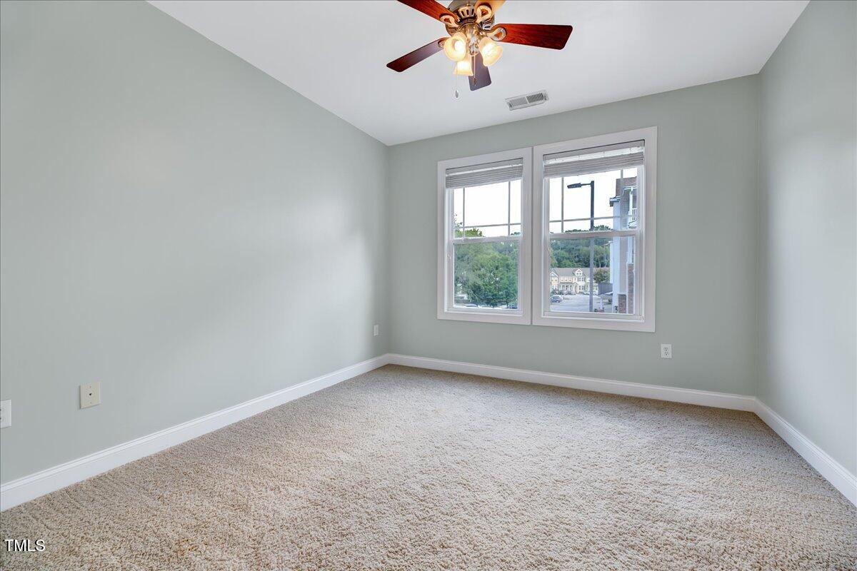 Undisclosed Address Raleigh, NC 27604 - Photo 10 of 22 an empty room with a window and a fan