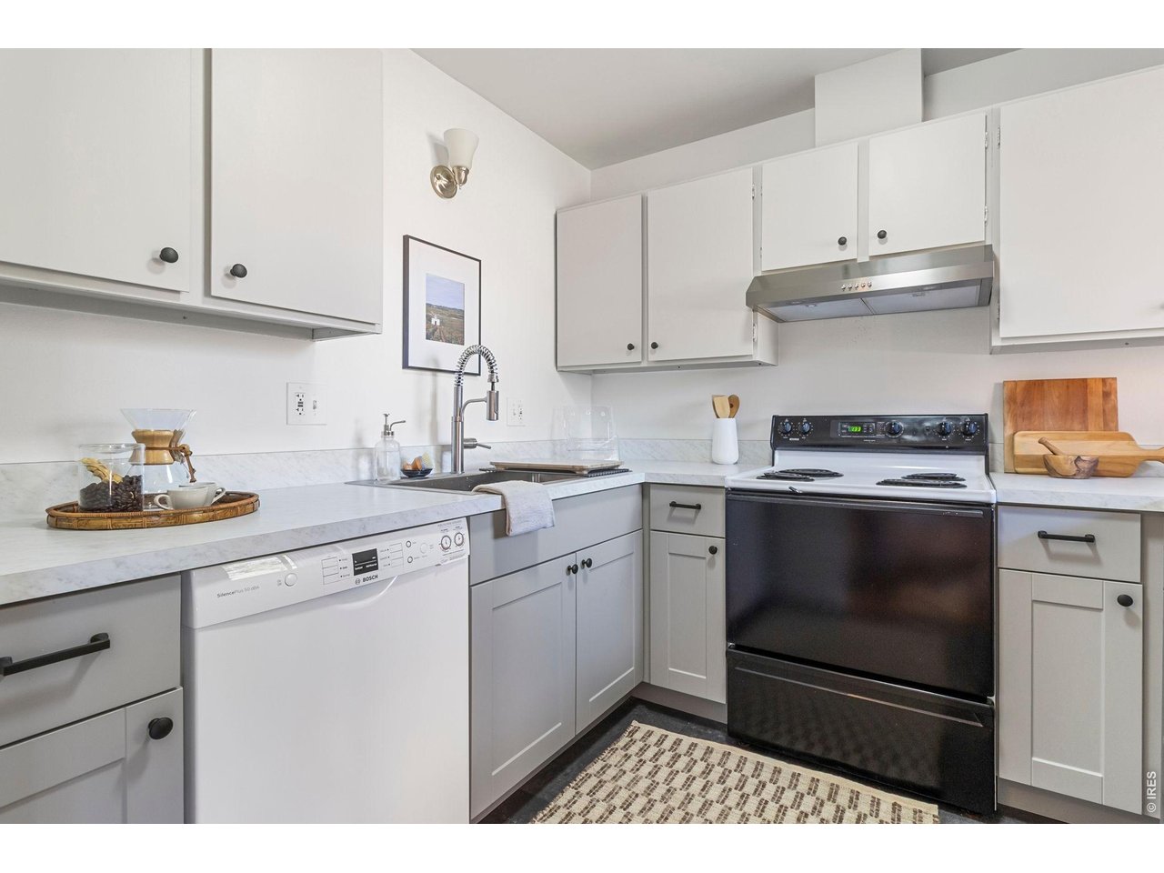 1625 West Elizabeth Street, Unit 1 Fort Collins, CO 80521 - Photo 5 of 16 a kitchen with granite countertop white cabinets and stainless steel appliances