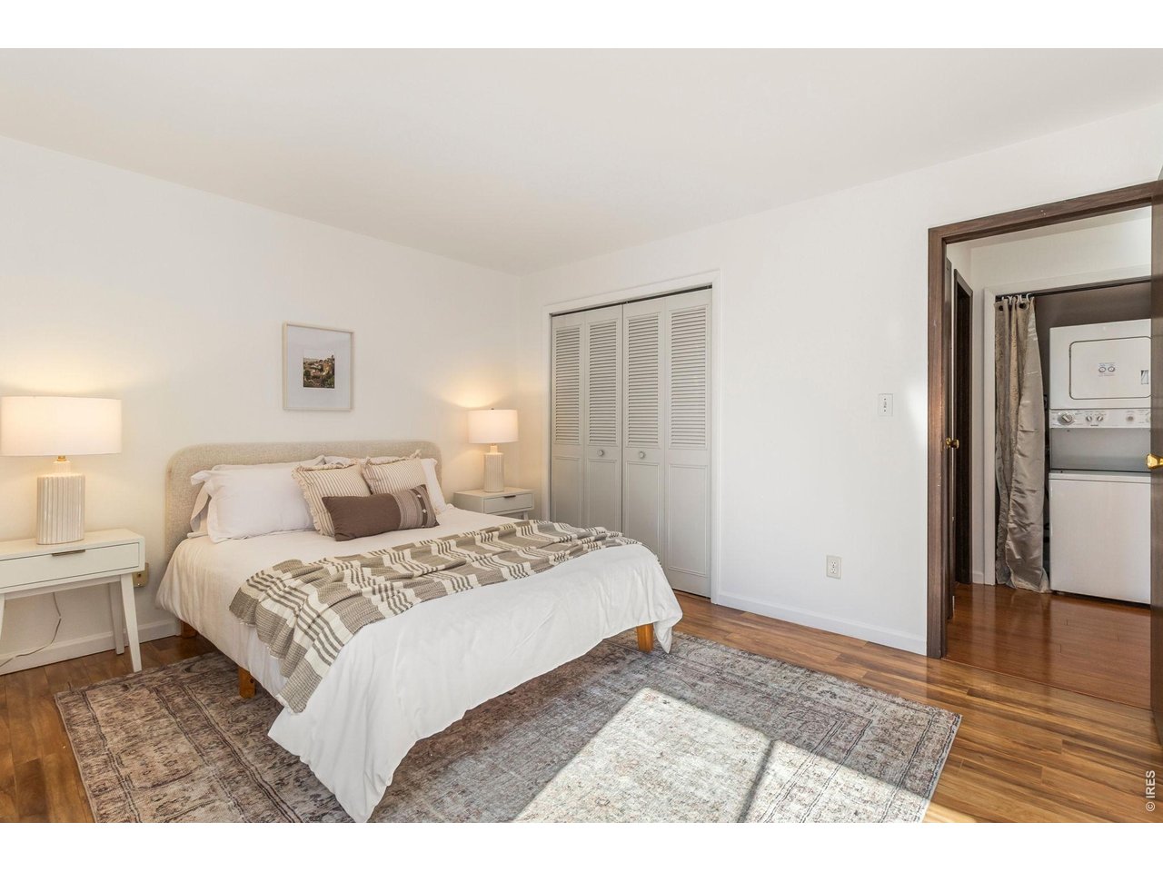 1625 West Elizabeth Street, Unit 1 Fort Collins, CO 80521 - Photo 8 of 16 a bedroom with a bed and wooden floor