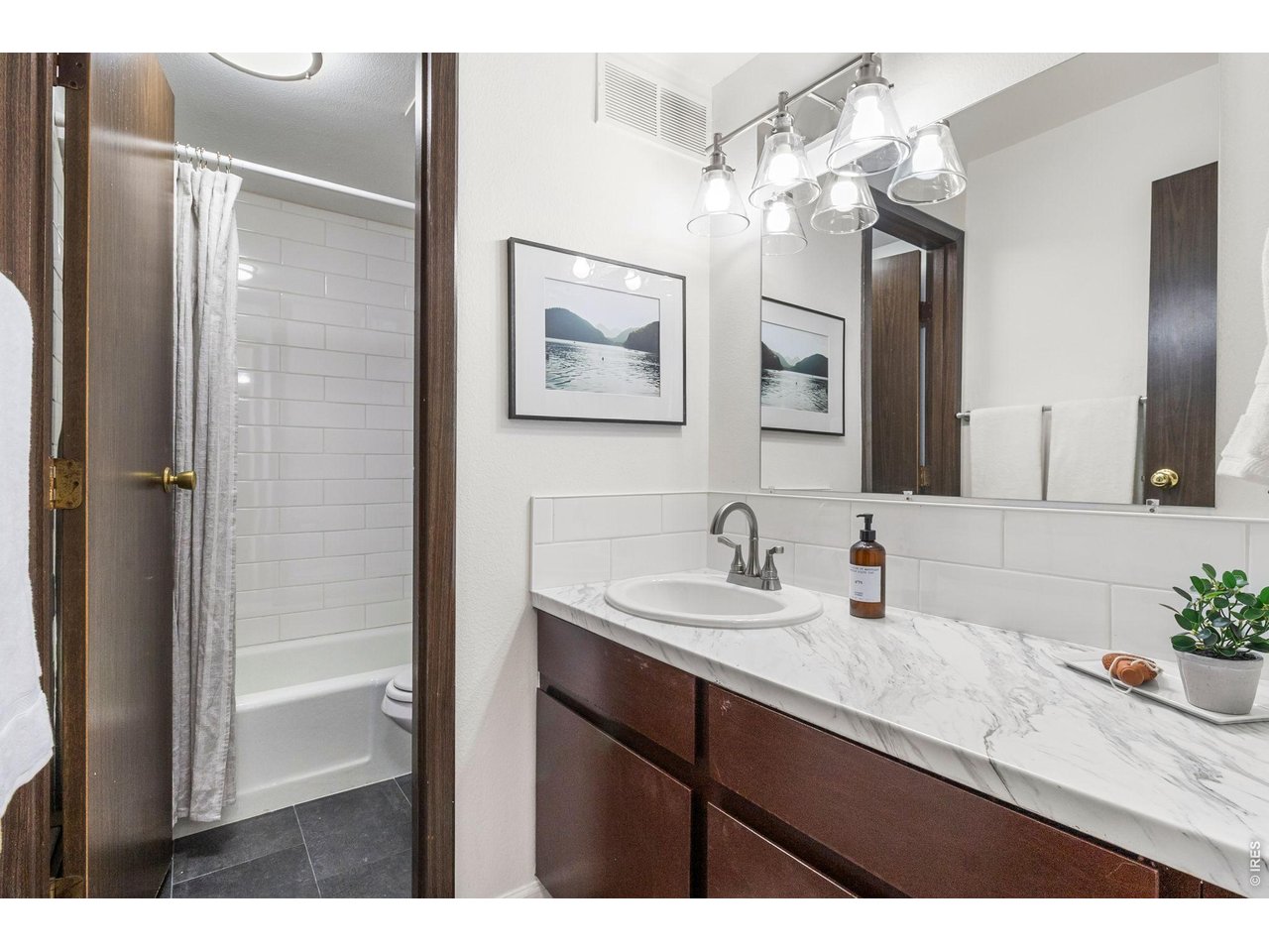 1625 West Elizabeth Street, Unit 1 Fort Collins, CO 80521 - Photo 10 of 16 a bathroom with a sink vanity and a mirror