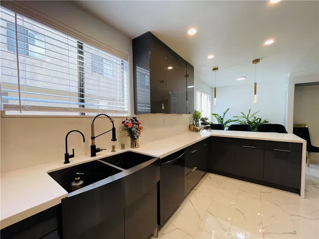 a kitchen with granite countertop a sink and a stove