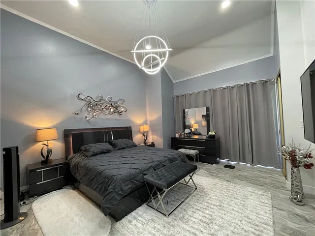 a bedroom with a bed and a chandelier