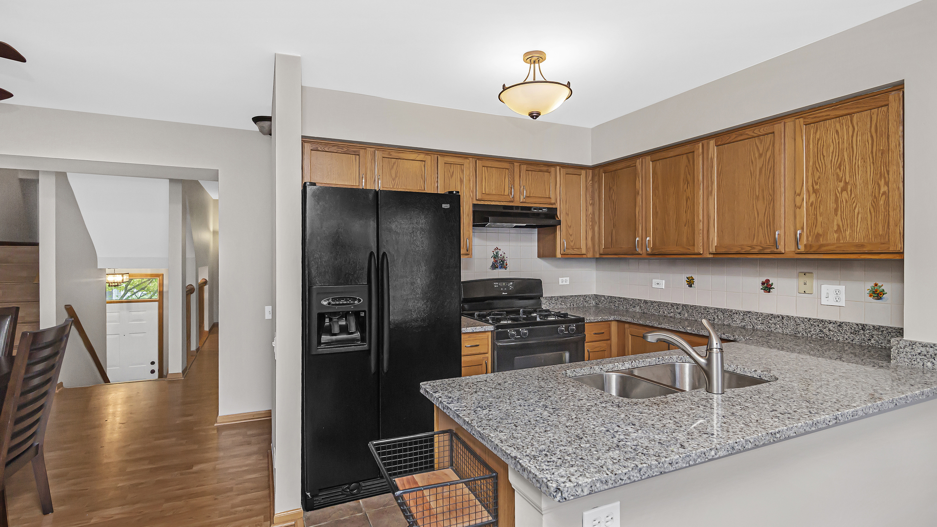 3159 Cambria Court Aurora, IL 60503 - Photo 2 of 21 a kitchen with stainless steel appliances granite countertop a refrigerator a stove and a sink