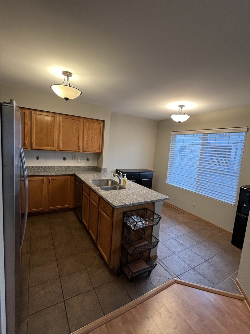 3159 Cambria Court Aurora, IL 60503 - Photo 21 of 21 a kitchen with stainless steel appliances granite countertop a stove a sink and a microwave