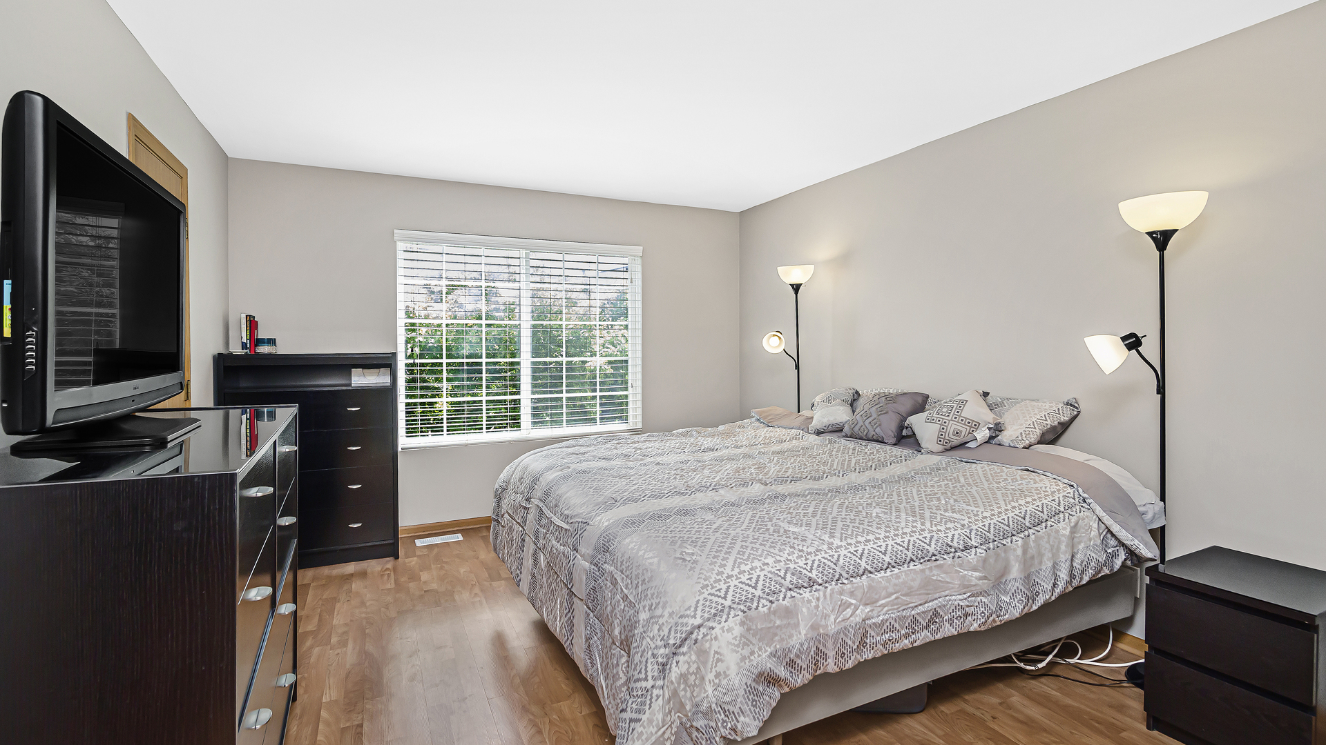 3159 Cambria Court Aurora, IL 60503 - Photo 9 of 21 a bedroom with a bed and a flat tv screen on a dresser