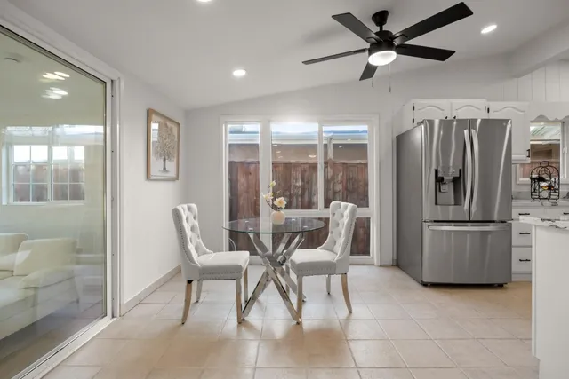 a dining room with furniture and a floor to ceiling window