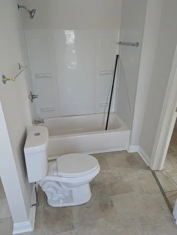 a bathroom with a toilet and a shower