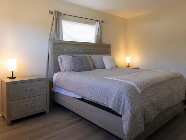 a bedroom with a bed and a window