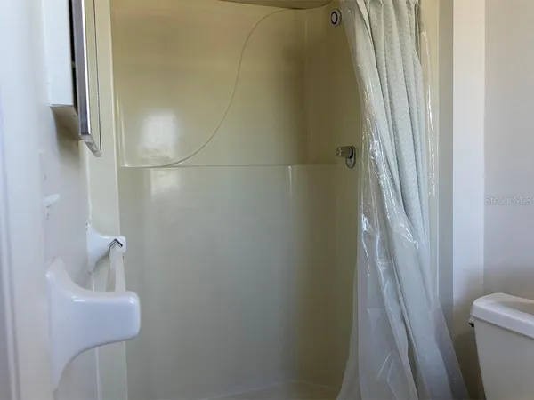 a bathroom with a shower and toilet