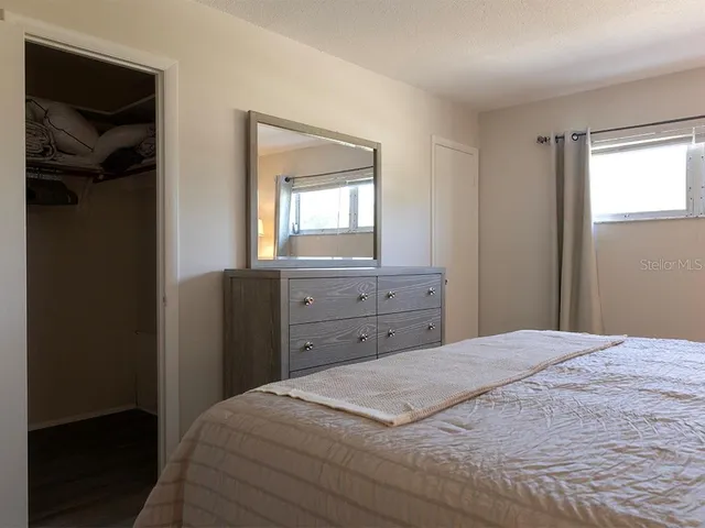 a bedroom with a bed and a mirror