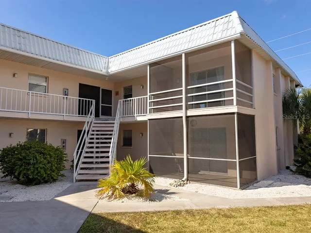 a view of an house with backyard space and balcony