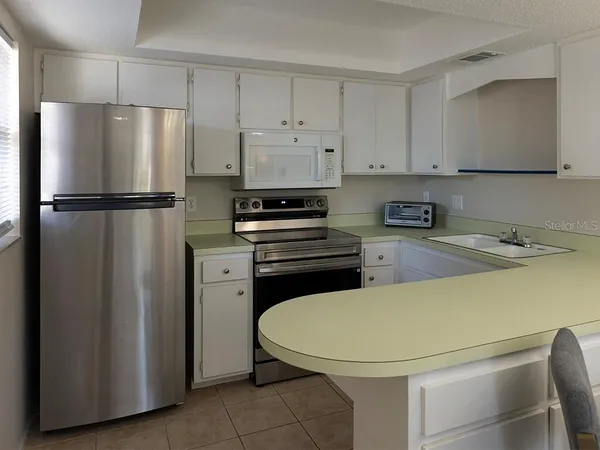 a kitchen with a refrigerator a stove and a sink