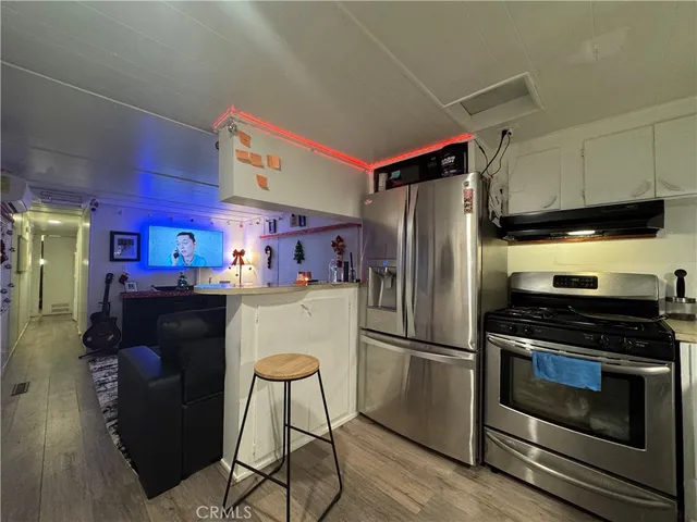 a kitchen with stainless steel appliances a refrigerator stove and microwave