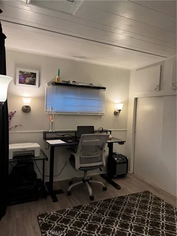 a room with furniture a air conditioner and a potted plant