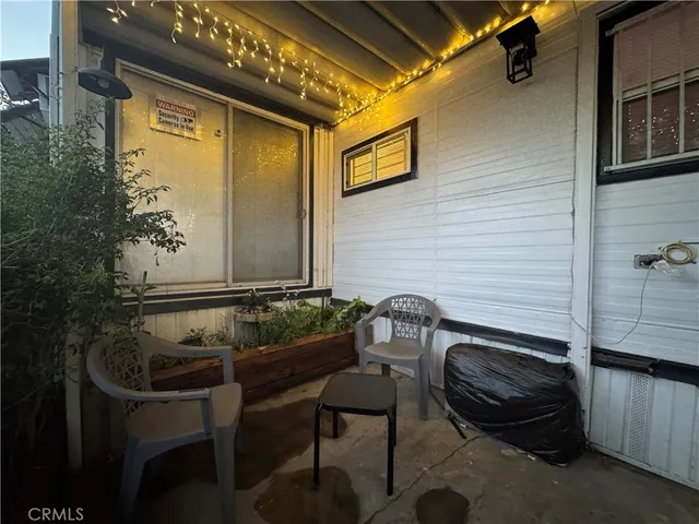 a balcony with table and chairs
