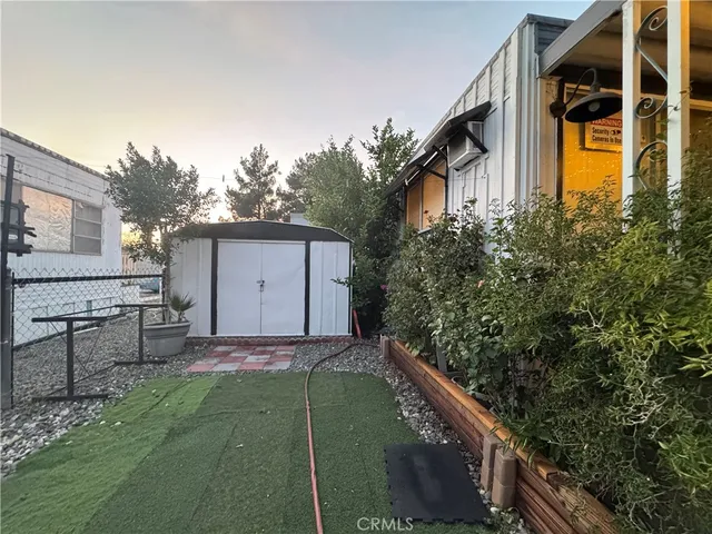 a backyard of a house with table and chairs