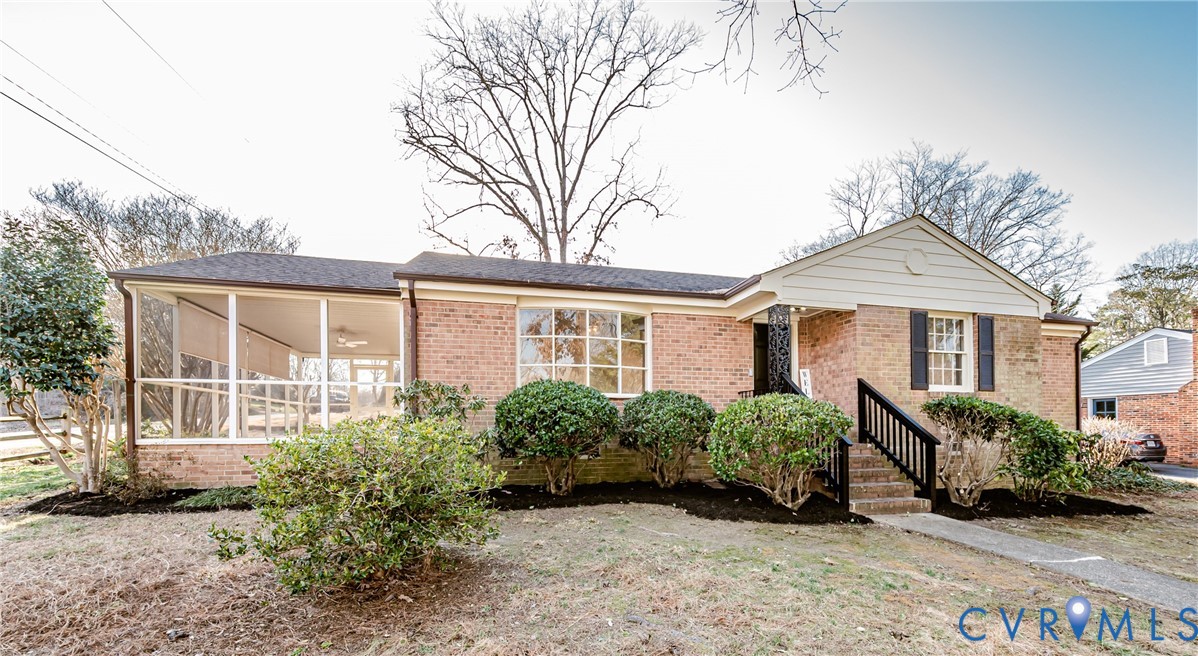 Ranch-style home with brick siding and a sunroom