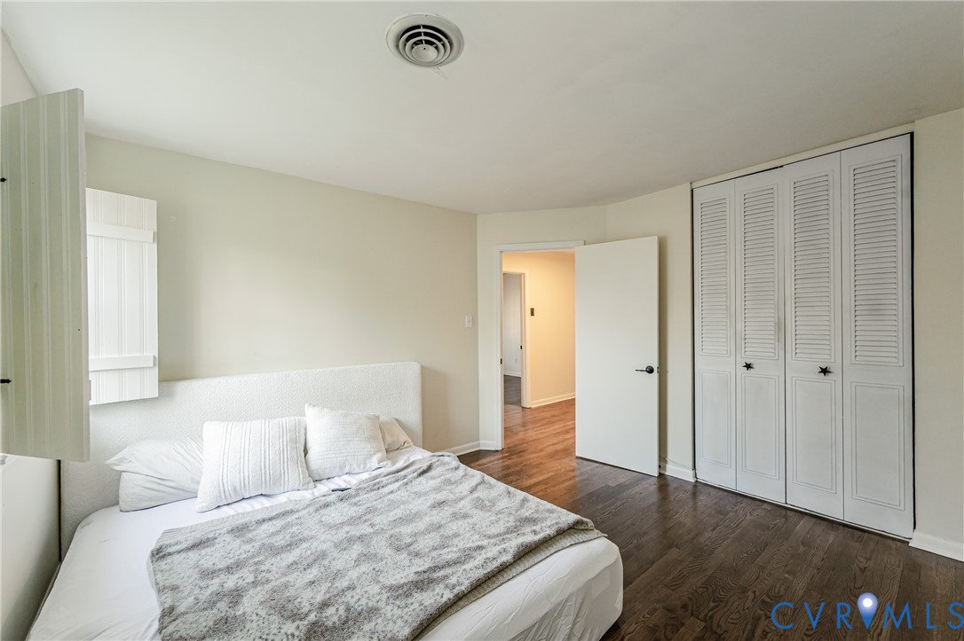 6048 Gainford Road Richmond, VA 23234 - Photo 18 of 83 Bedroom with dark wood-type flooring and a closet