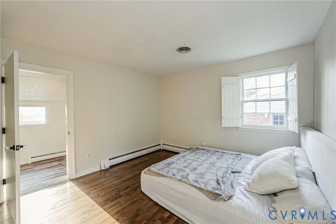 6048 Gainford Road Richmond, VA 23234 - Photo 20 of 83 Bedroom with dark wood-type flooring and a baseboa