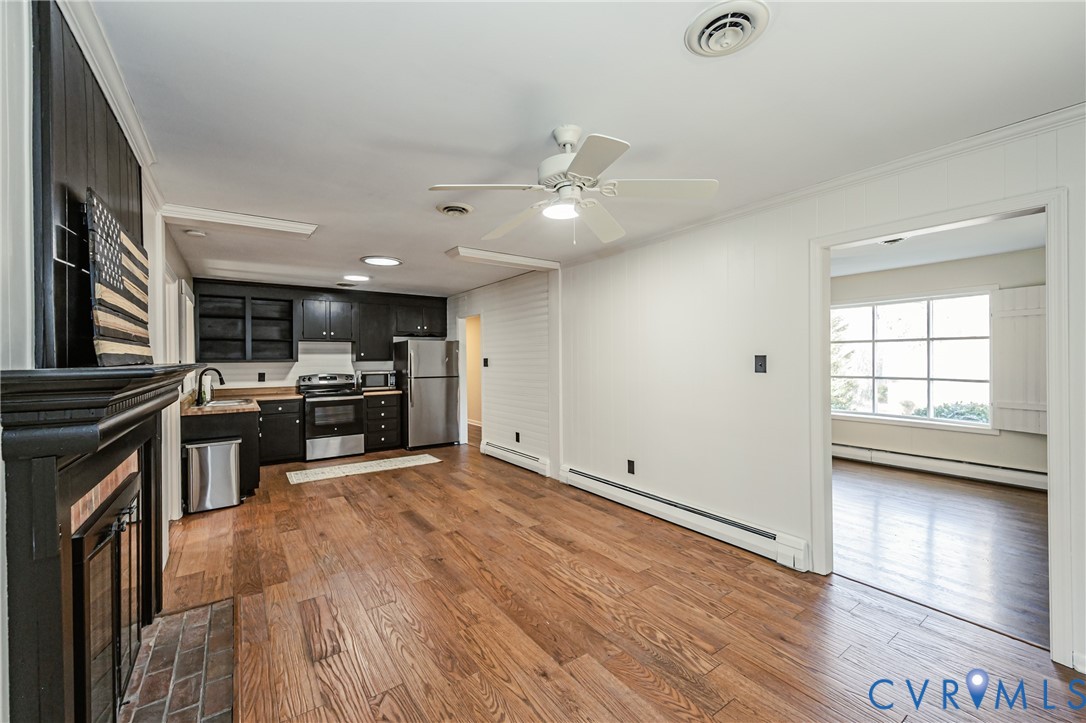 6048 Gainford Road Richmond, VA 23234 - Photo 51 of 83 Kitchen featuring dark cabinets, a baseboard radia