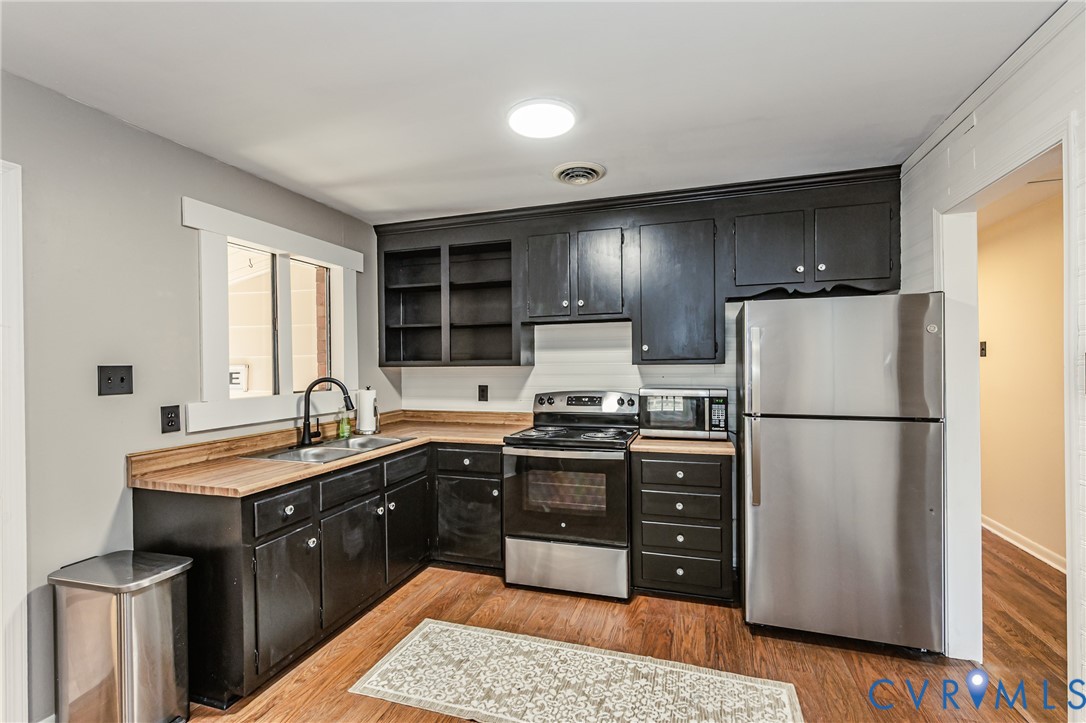 6048 Gainford Road Richmond, VA 23234 - Photo 59 of 83 Kitchen featuring dark cabinets, stainless steel a