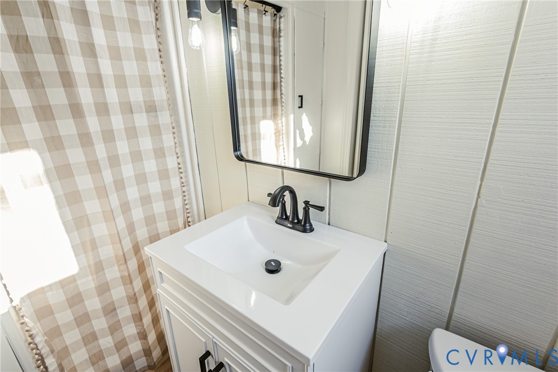6048 Gainford Road Richmond, VA 23234 - Photo 64 of 83 Bathroom featuring vanity and wallpapered walls
