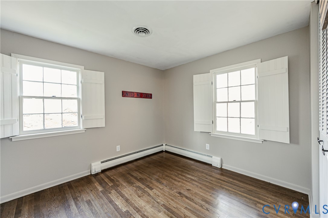 6048 Gainford Road Richmond, VA 23234 - Photo 80 of 83 Spare room with dark wood-style flooring and baseb