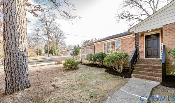 a front view of a house with a yard covered in snow