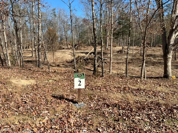 a blue sign board with tall trees