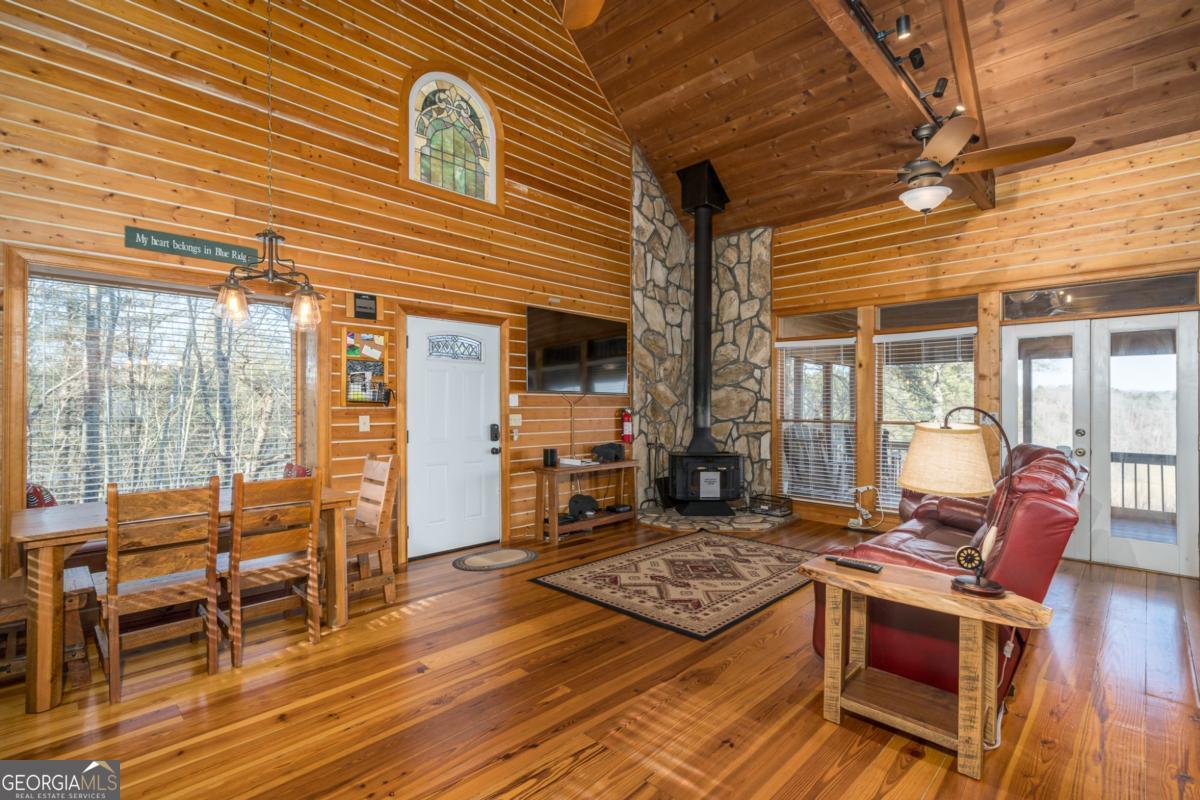 517 Ridge Road Blue Ridge, GA 30513 - Photo 13 of 56 a living room with furniture a wooden floor and next to a window