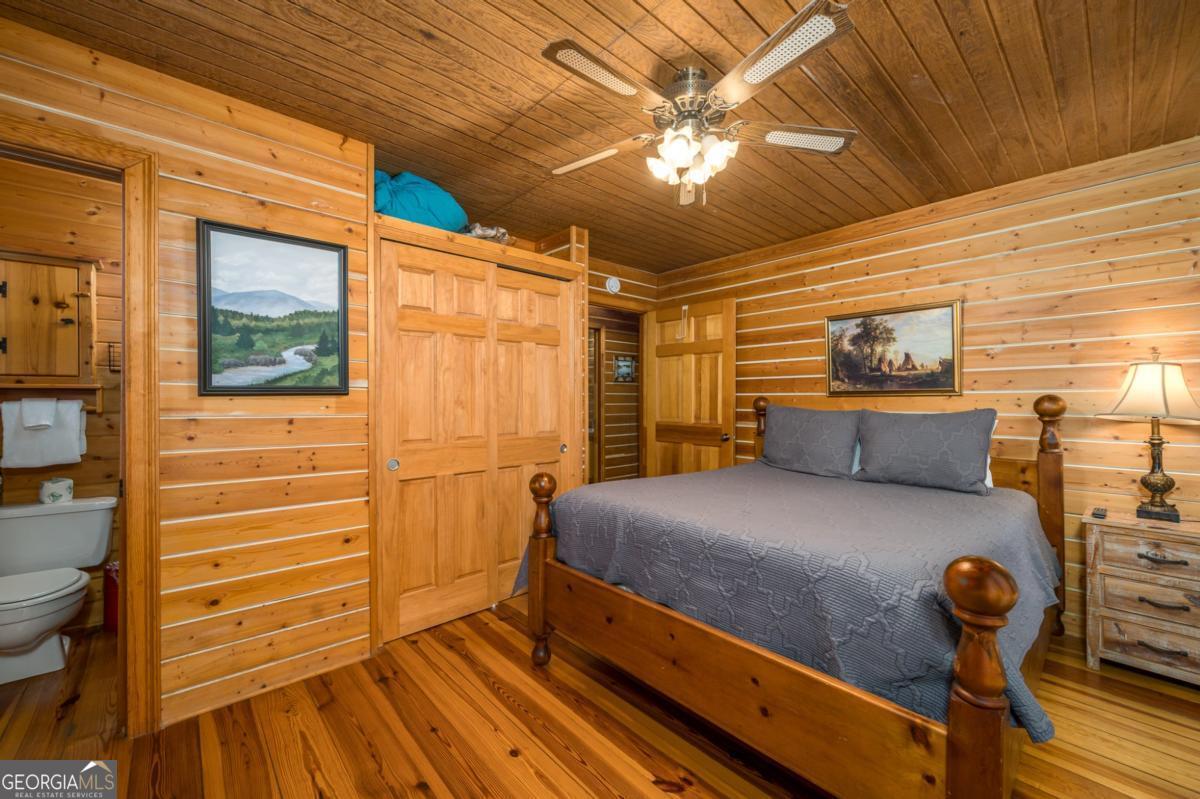 517 Ridge Road Blue Ridge, GA 30513 - Photo 25 of 56 a bedroom with a bed and wooden floor