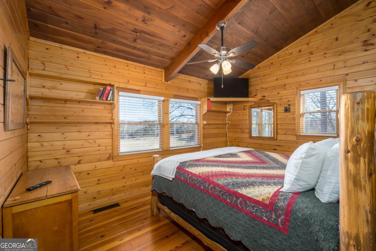 517 Ridge Road Blue Ridge, GA 30513 - Photo 29 of 56 a bed sitting in a bedroom next to a window