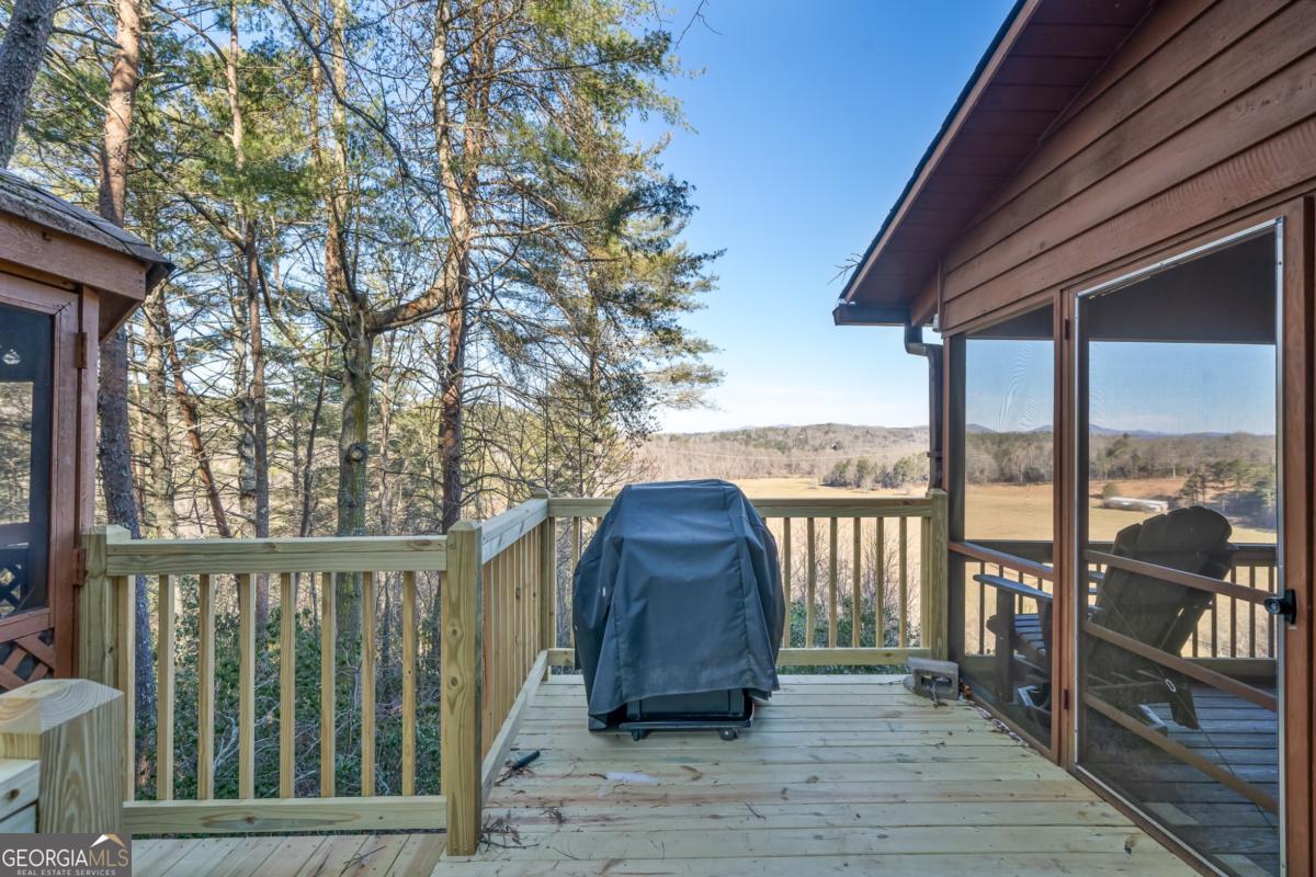 517 Ridge Road Blue Ridge, GA 30513 - Photo 34 of 56 a view of a balcony with wooden floor and fence