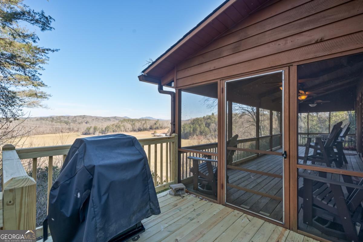 517 Ridge Road Blue Ridge, GA 30513 - Photo 35 of 56 a view of a balcony with wooden floor and outdoor seating